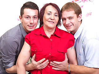 Naughty mature lady sucking and fucking two guys at once